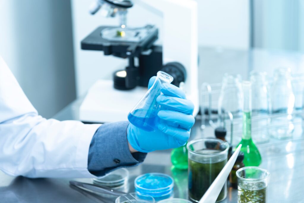 A person holds a test tube in a lab.