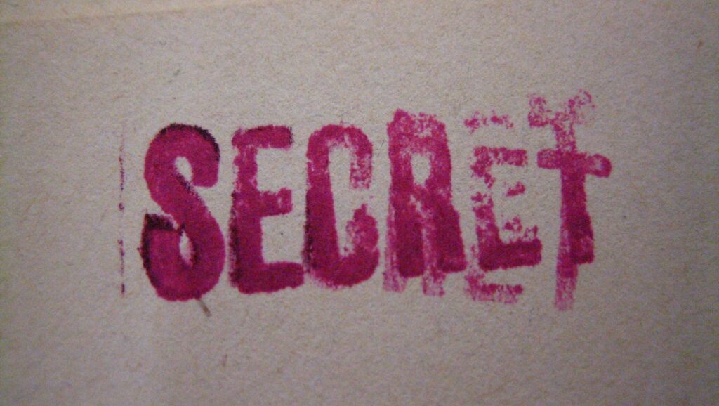 Blurred purple stamp on document, reading 