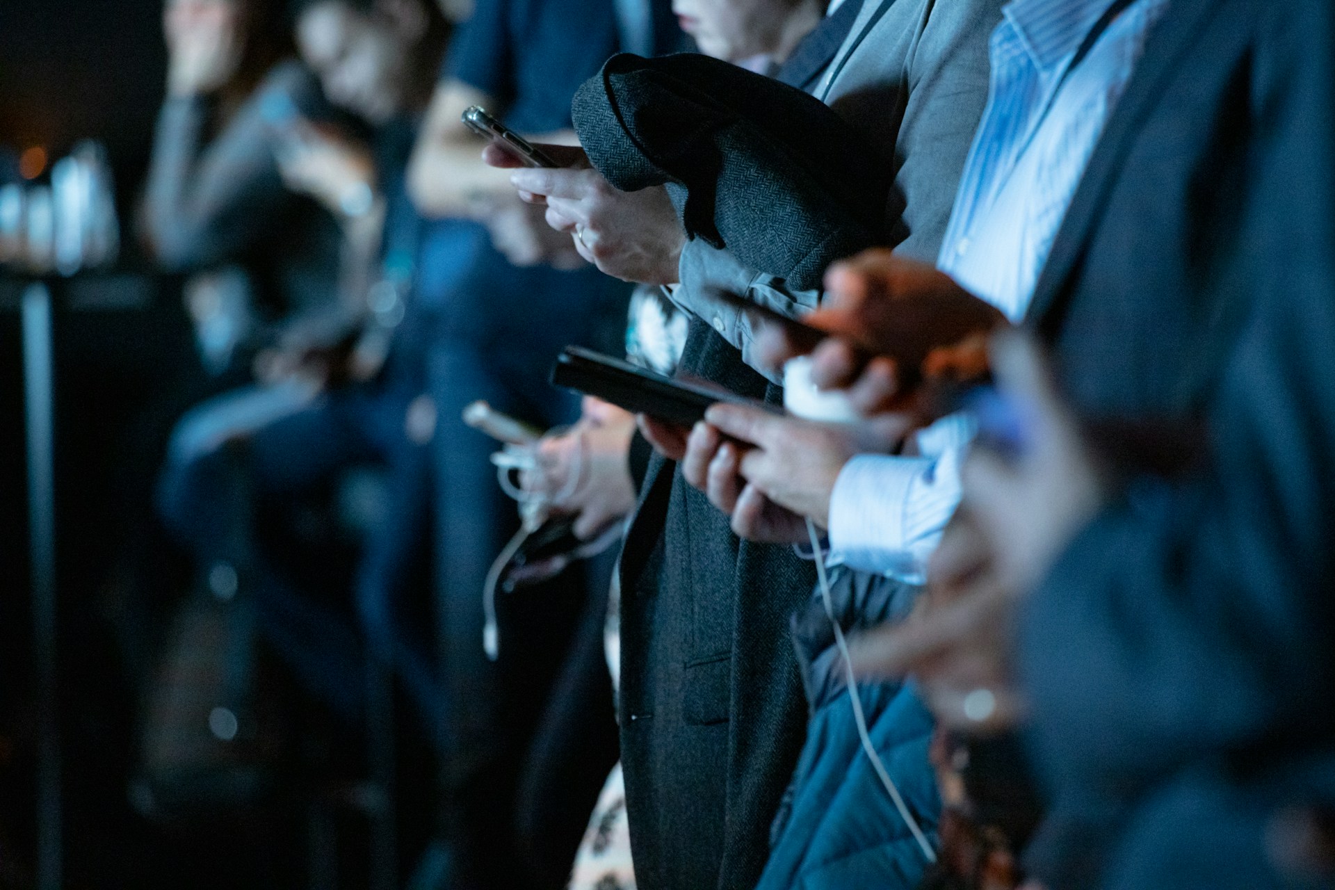 Businesspeople using phones while standing